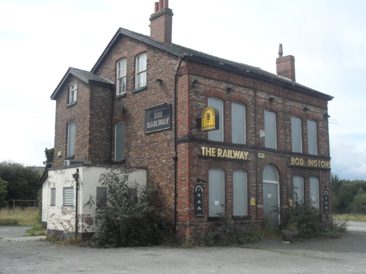a red brick building with the word the railway is painted yellow