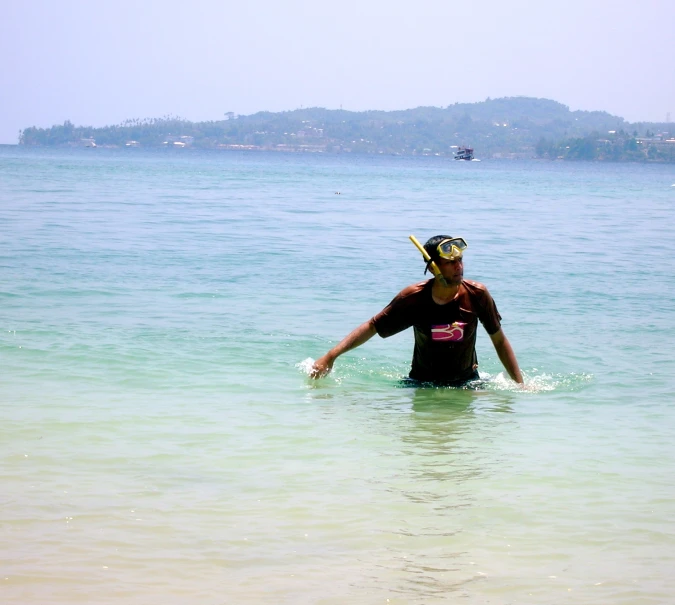 a woman wearing a mask and a helmet in the water