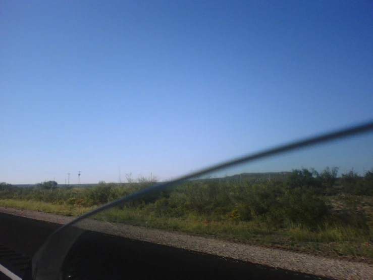 view from the windshield of a vehicle in a rural area