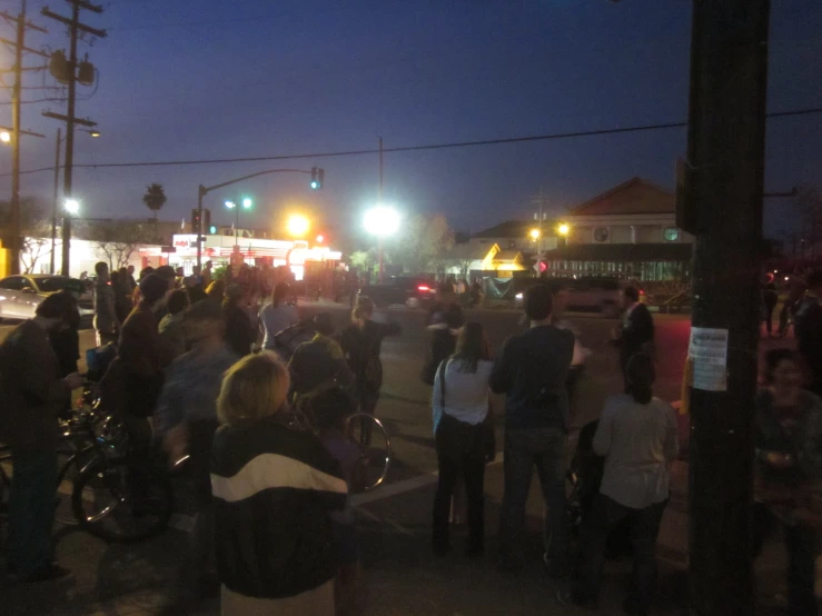 a group of people that are standing around in the street