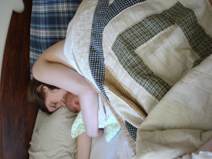 a person sleeping on the bed under the covers