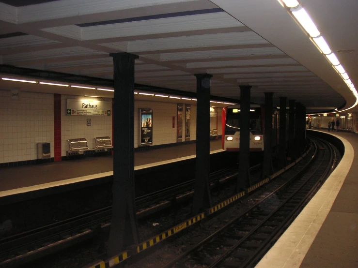 a subway stop with a long train on the tracks