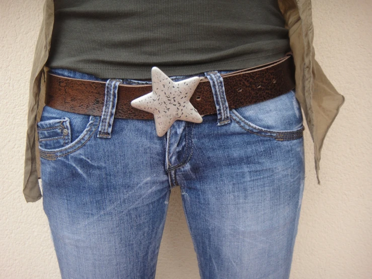 a person wearing a belt with a white star on it