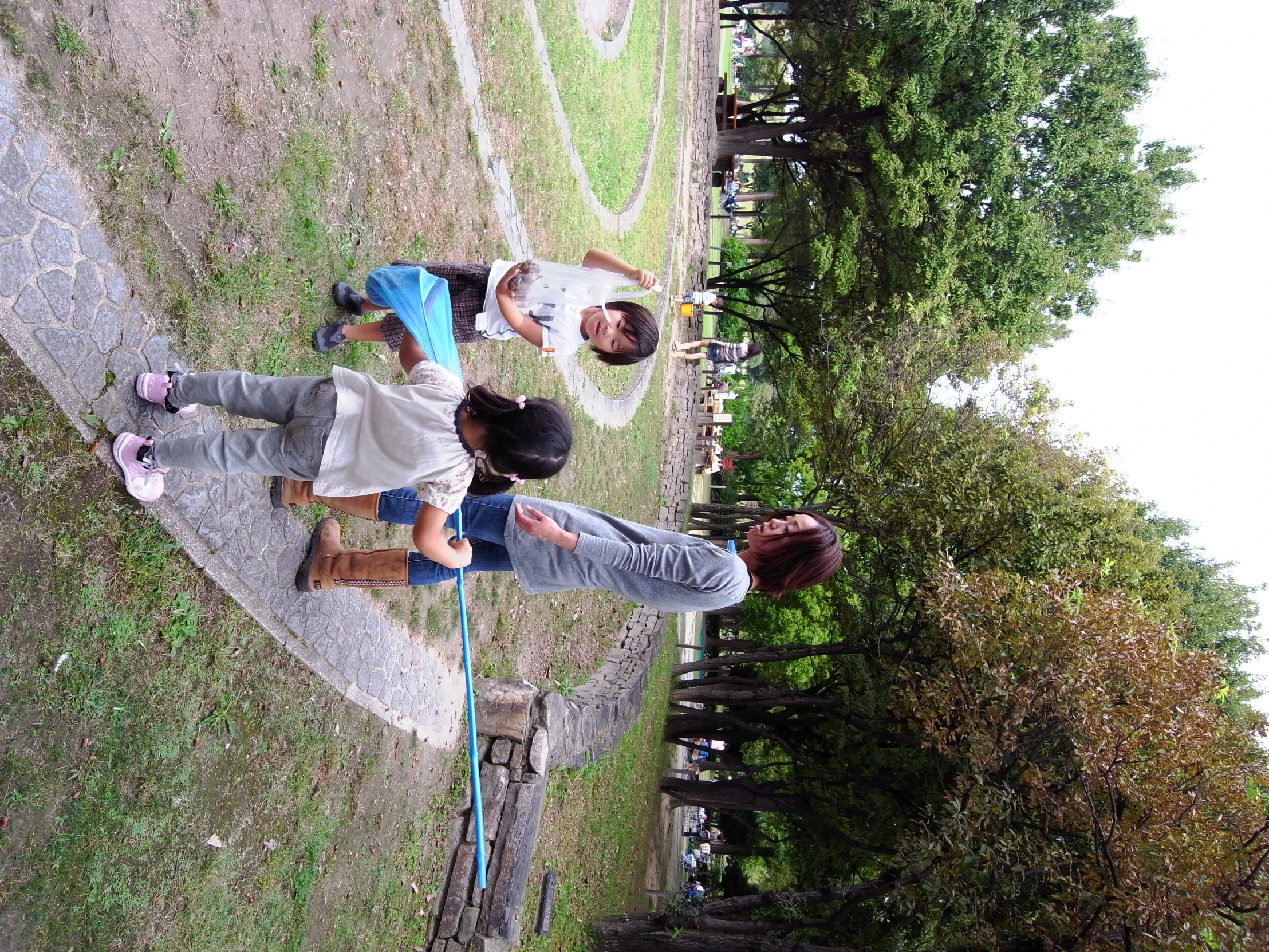 people and small children play on a path