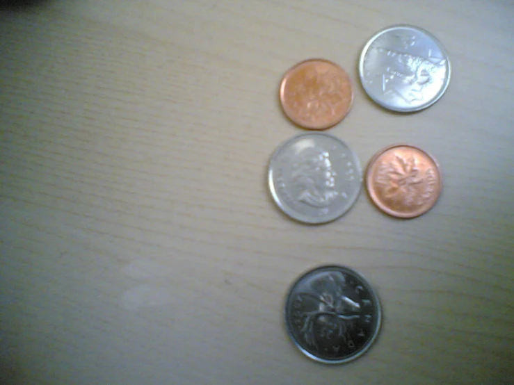 four quarters sitting next to each other on a table