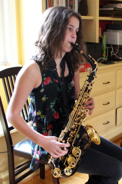 the  is playing her saxophone in the room