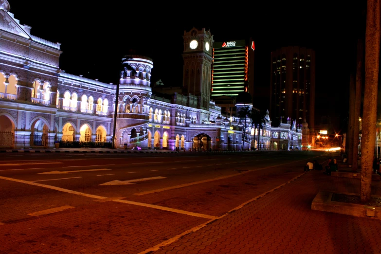 a city street with a lot of buildings at night