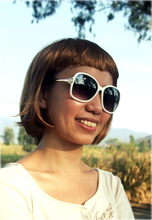 a woman with glasses that have white rimmed sunglasses