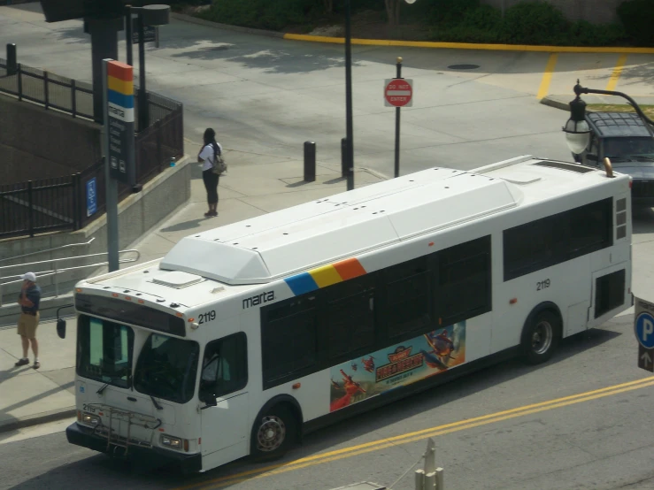 there is a large bus stopped at the stop