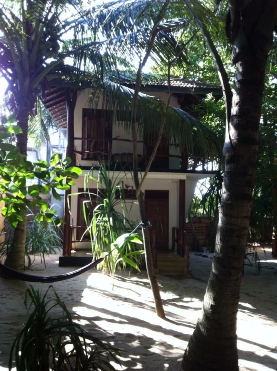 a hammock set up by the side of a house