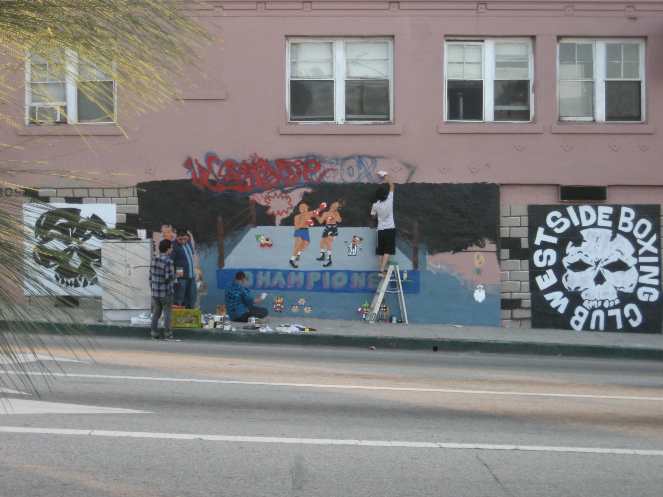 the front of a building with several colorful paintings