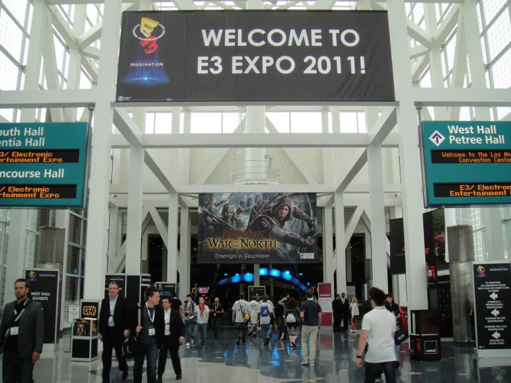 a sign welcomes visitors into an indoor convention