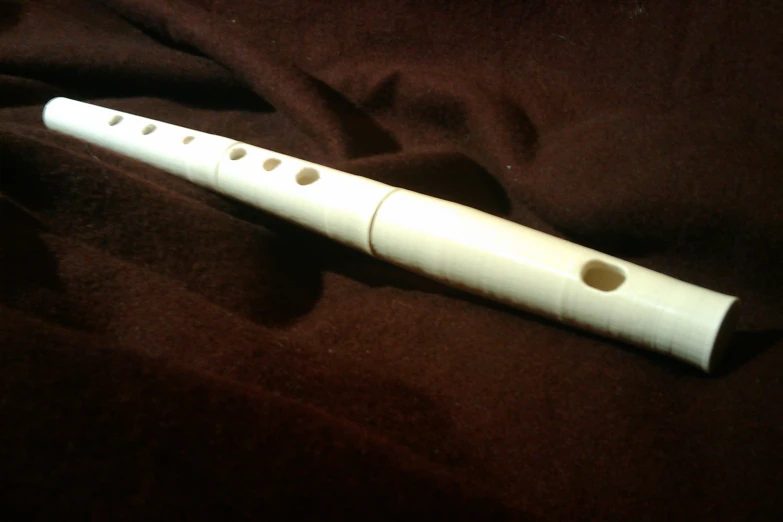 a white flute sitting on top of a bed