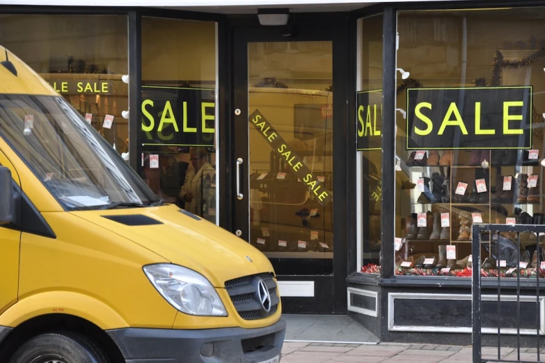 yellow van parked outside a store in front of its doors