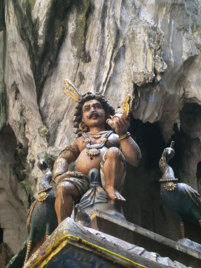 statue in a cave near large rock formation