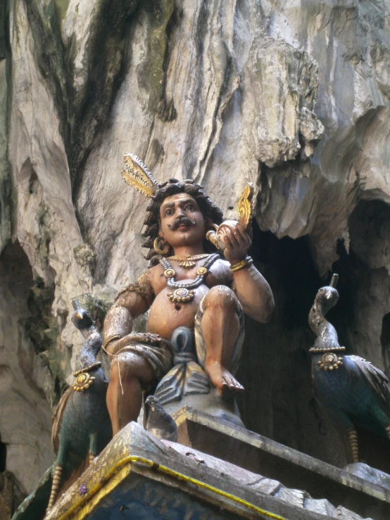 statue in a cave near large rock formation