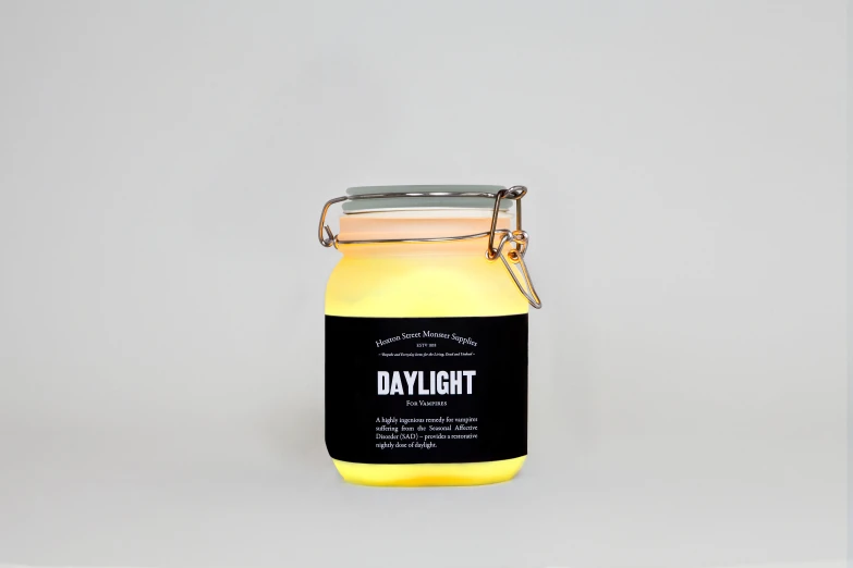 a yellow and black jar that says daktlight