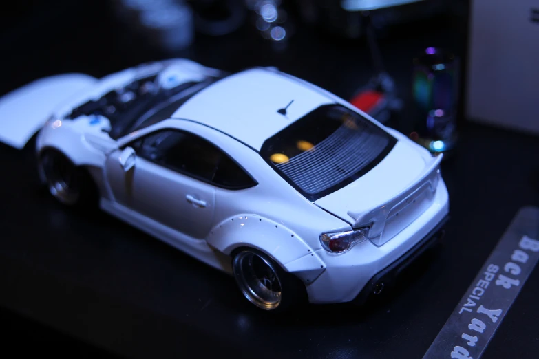 white model car on black table with other items in background