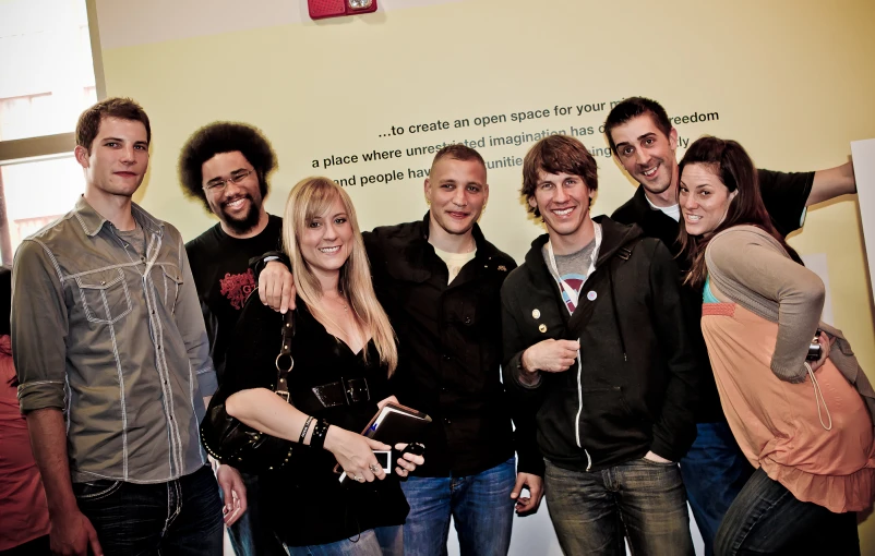 a group of people standing and posing for the camera