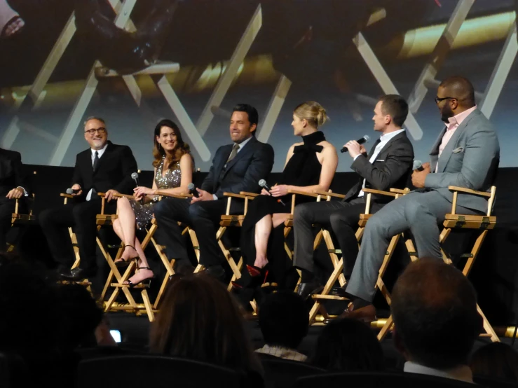 several actors sitting down for a panel at an event