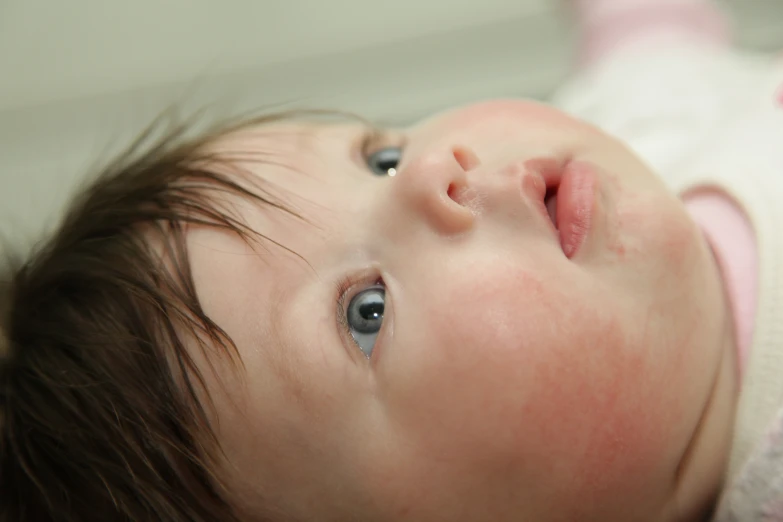 a close up view of a baby looking straight ahead