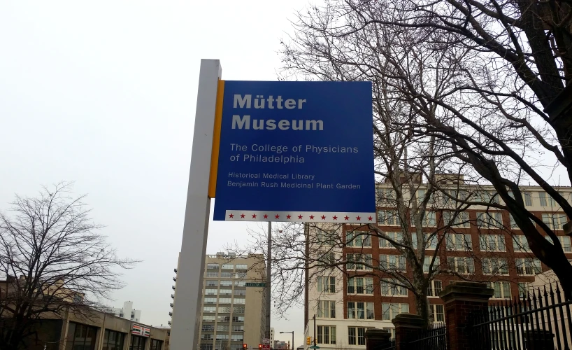a blue sign near a row of buildings