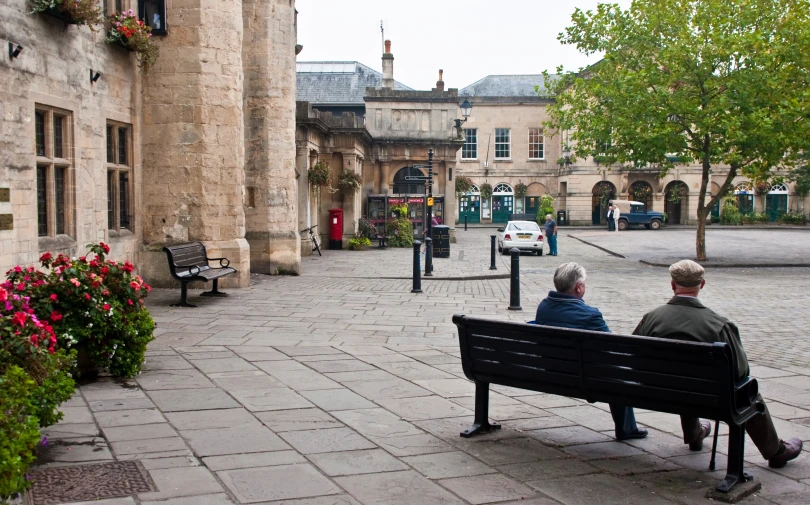 there are two people that are sitting on the bench