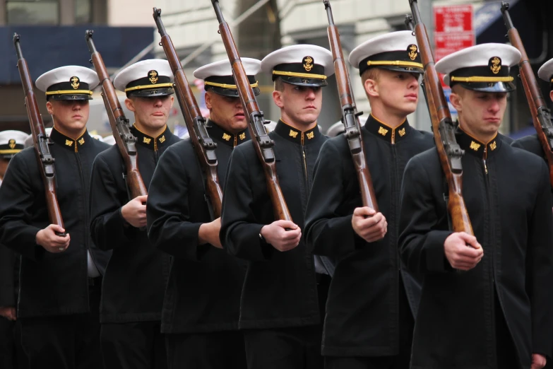 some soldiers are marching with rifles on their backs