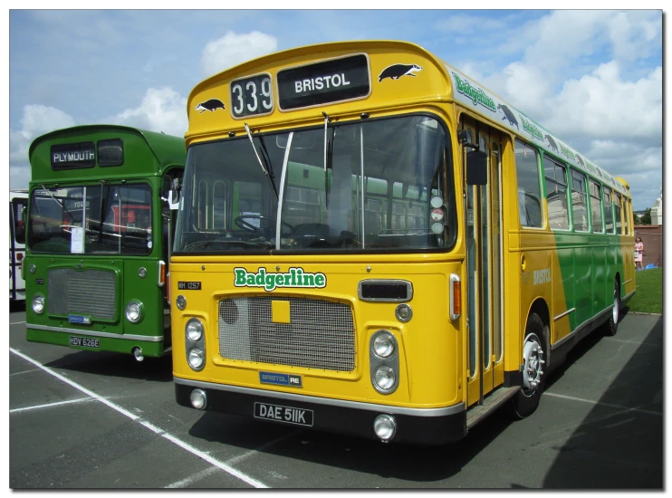 two buses parked side by side on a parking lot