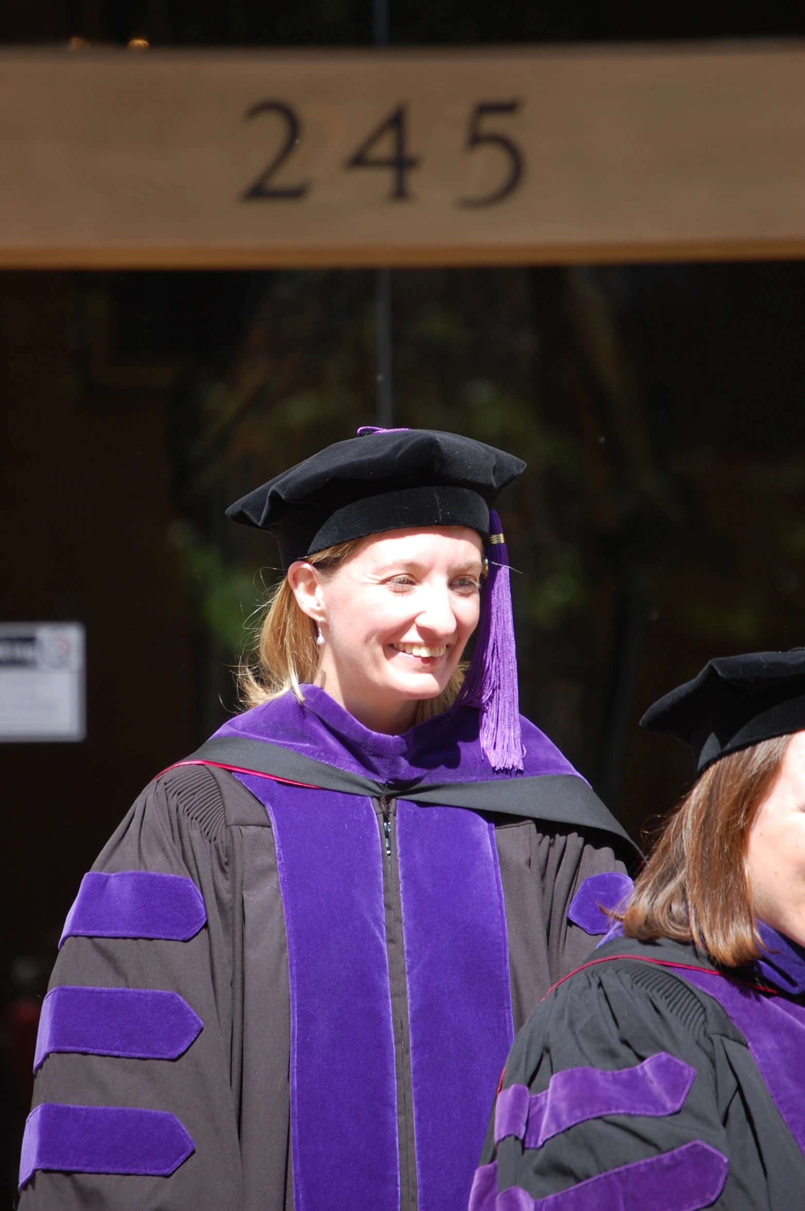 a couple of women standing next to each other in graduation robes