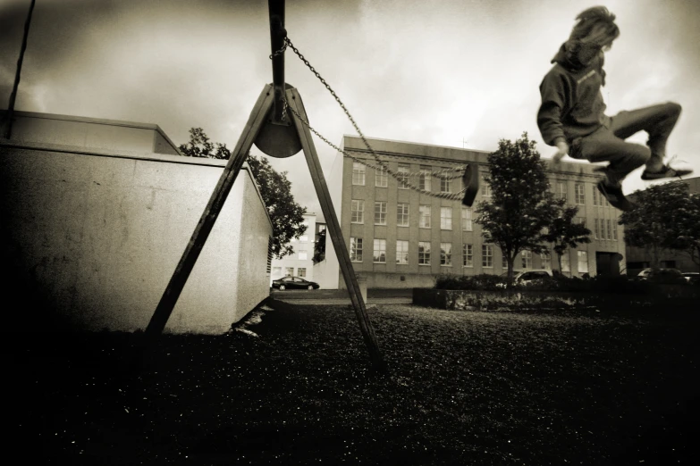 a girl swings on a swing in a backyard