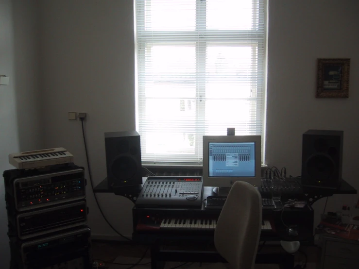 an electronic keyboard and music equipment are set up in a living room