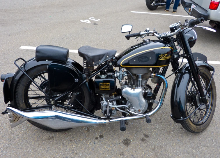 there is a black and gold motorcycle in the parking lot