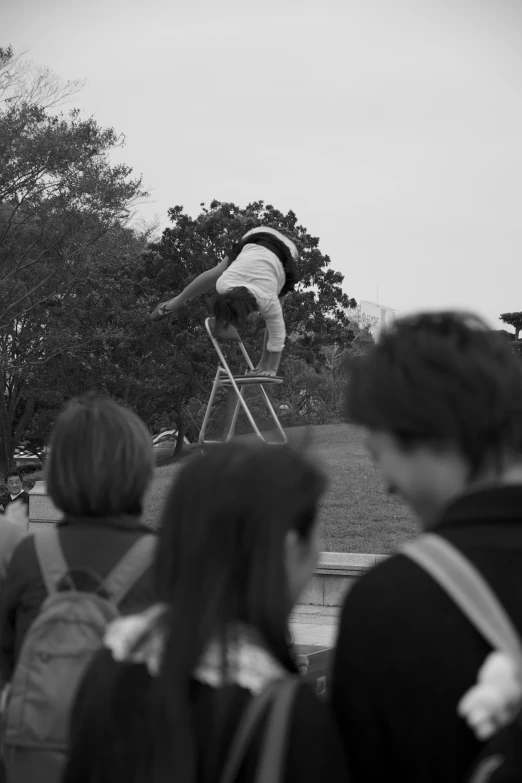 man on a skateboard doing tricks in a crowd