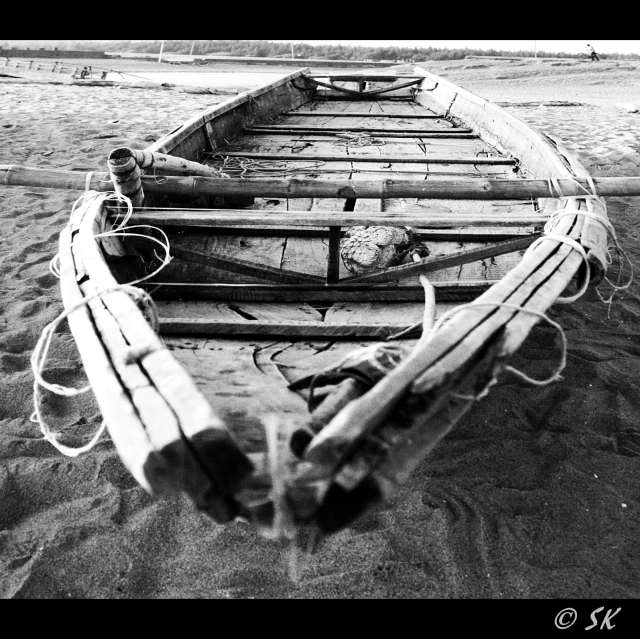 a old wooden boat is on the beach