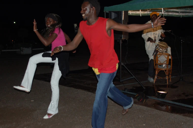 some young men are dancing and a pink shirt