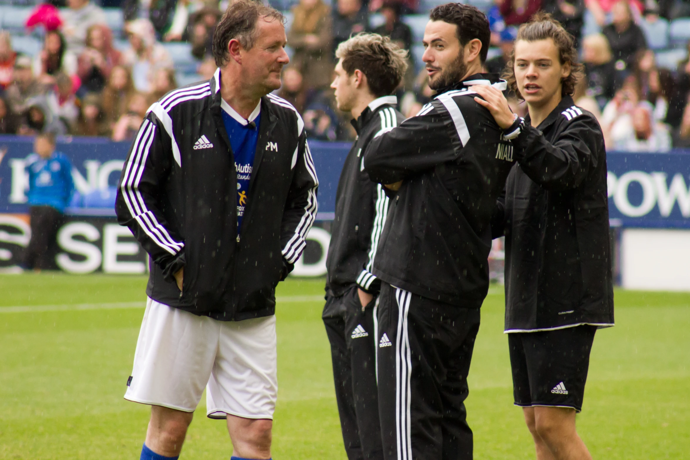 men on a soccer field talk to each other