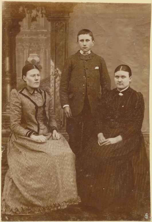 an old black and white pograph of three people