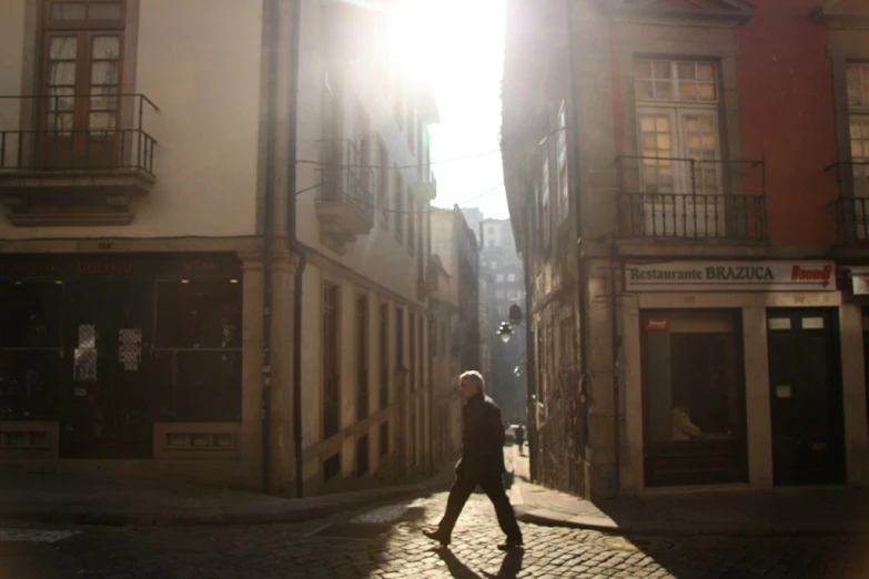 a person that is walking down a narrow street
