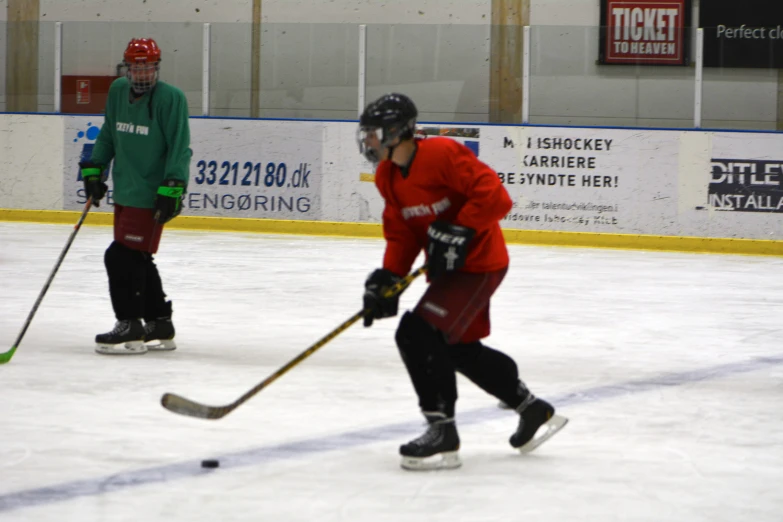 two men in uniforms playing a game of ice hockey