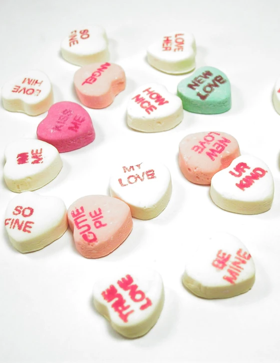 candy hearts in conversation on white background with chinese writing