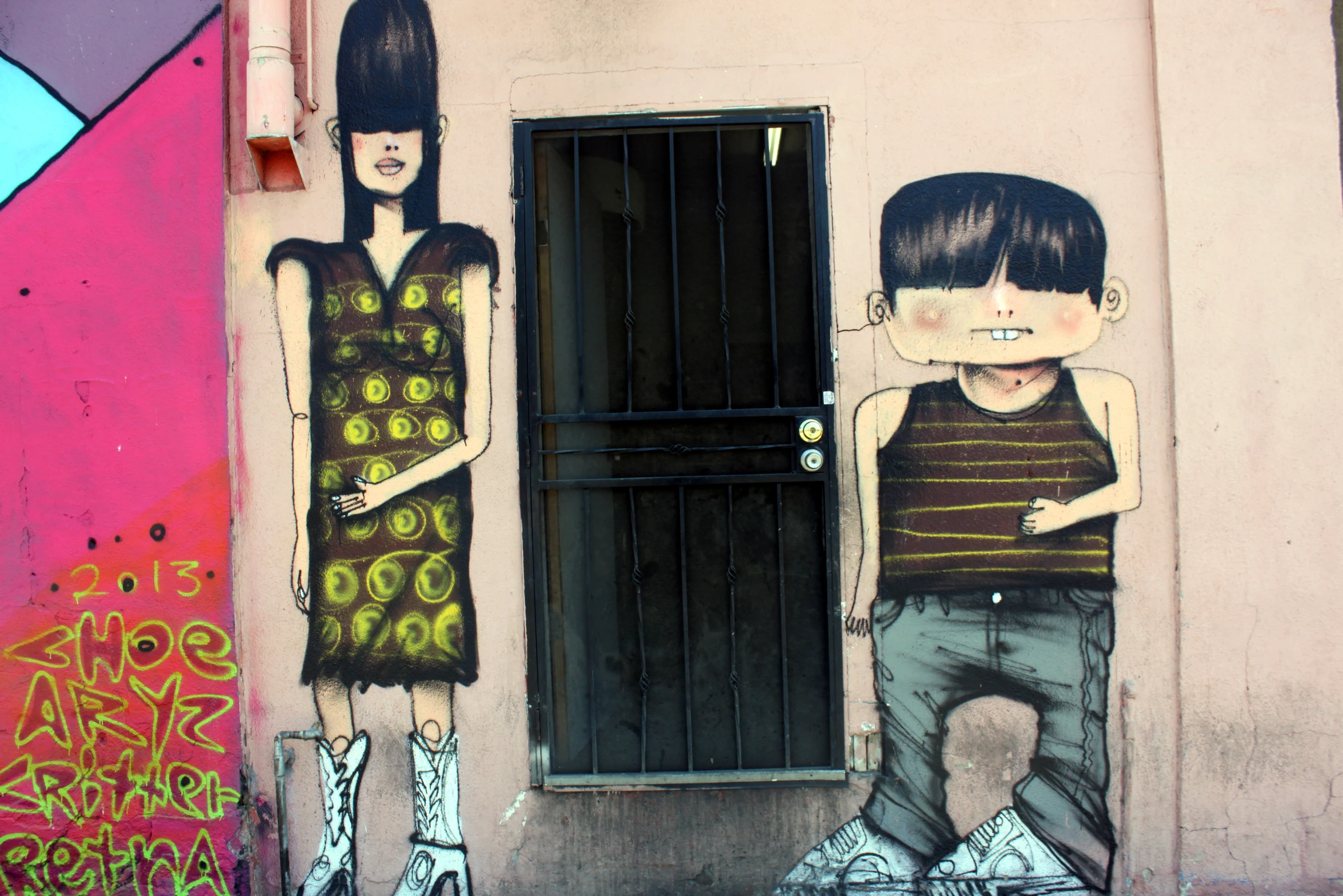 two children painted on the side of a building