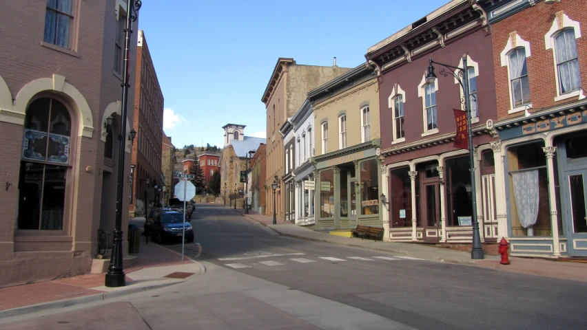 a street corner with buildings and parked cars