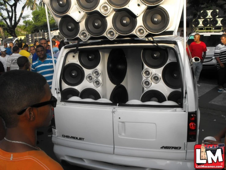 the back end of a truck is packed with speakers