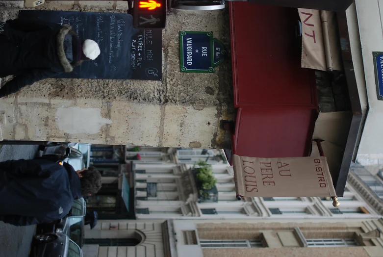 two people walking down the street with some signs