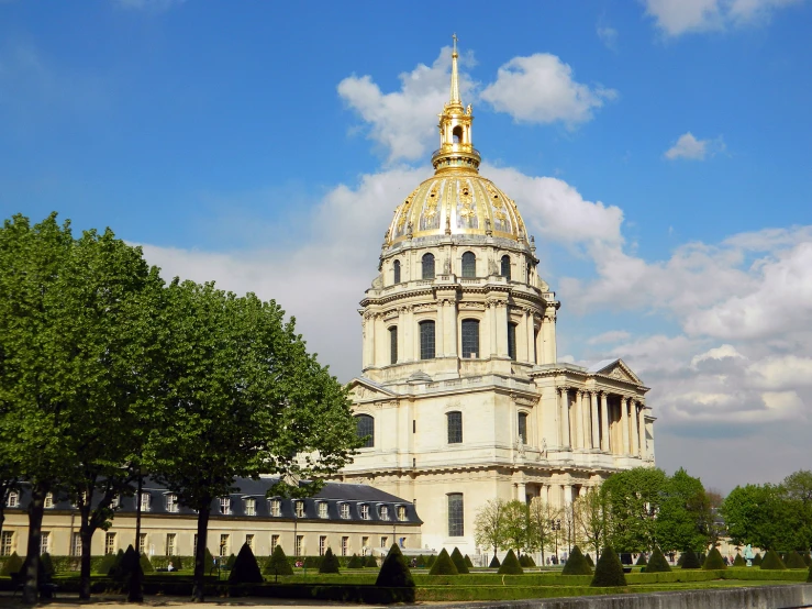 a large white building with a gold domed and a tower