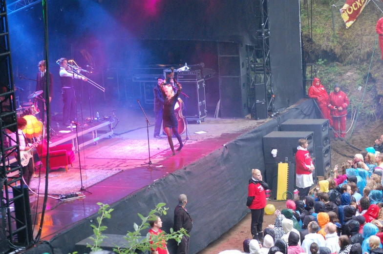 a group of people are performing on a stage