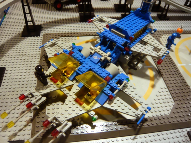 a lego airplane sits in front of people