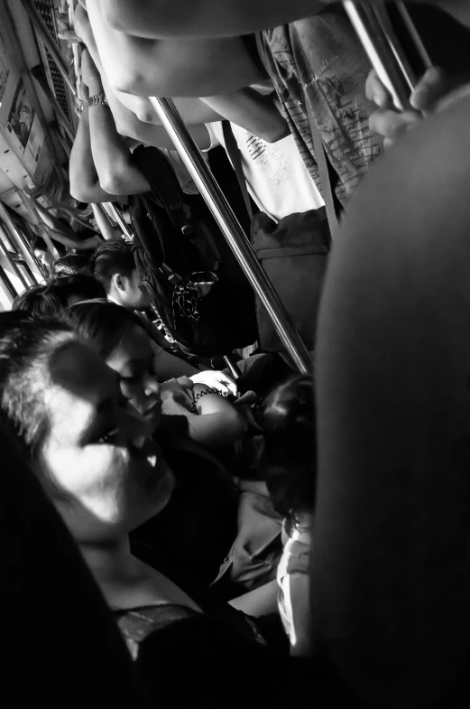 a group of people sitting on a bus and two adults watching