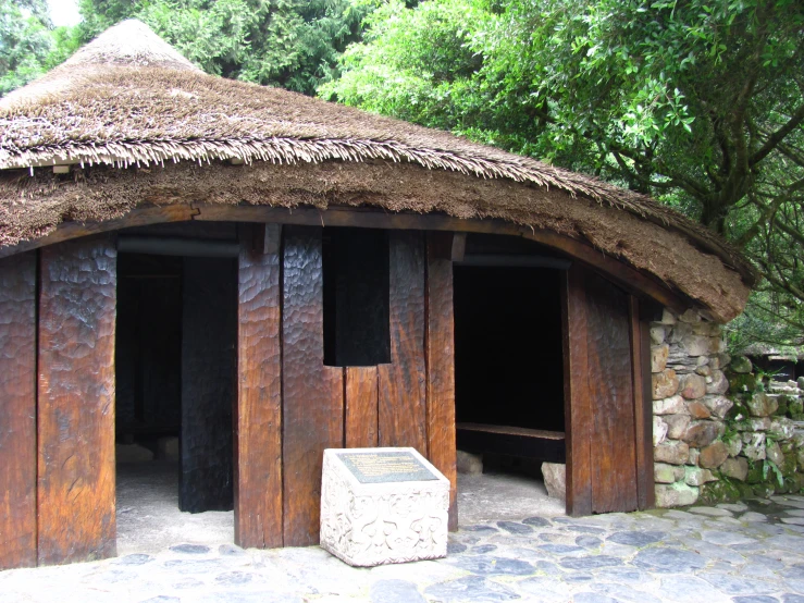 a very large thatched roof covered with brown straw